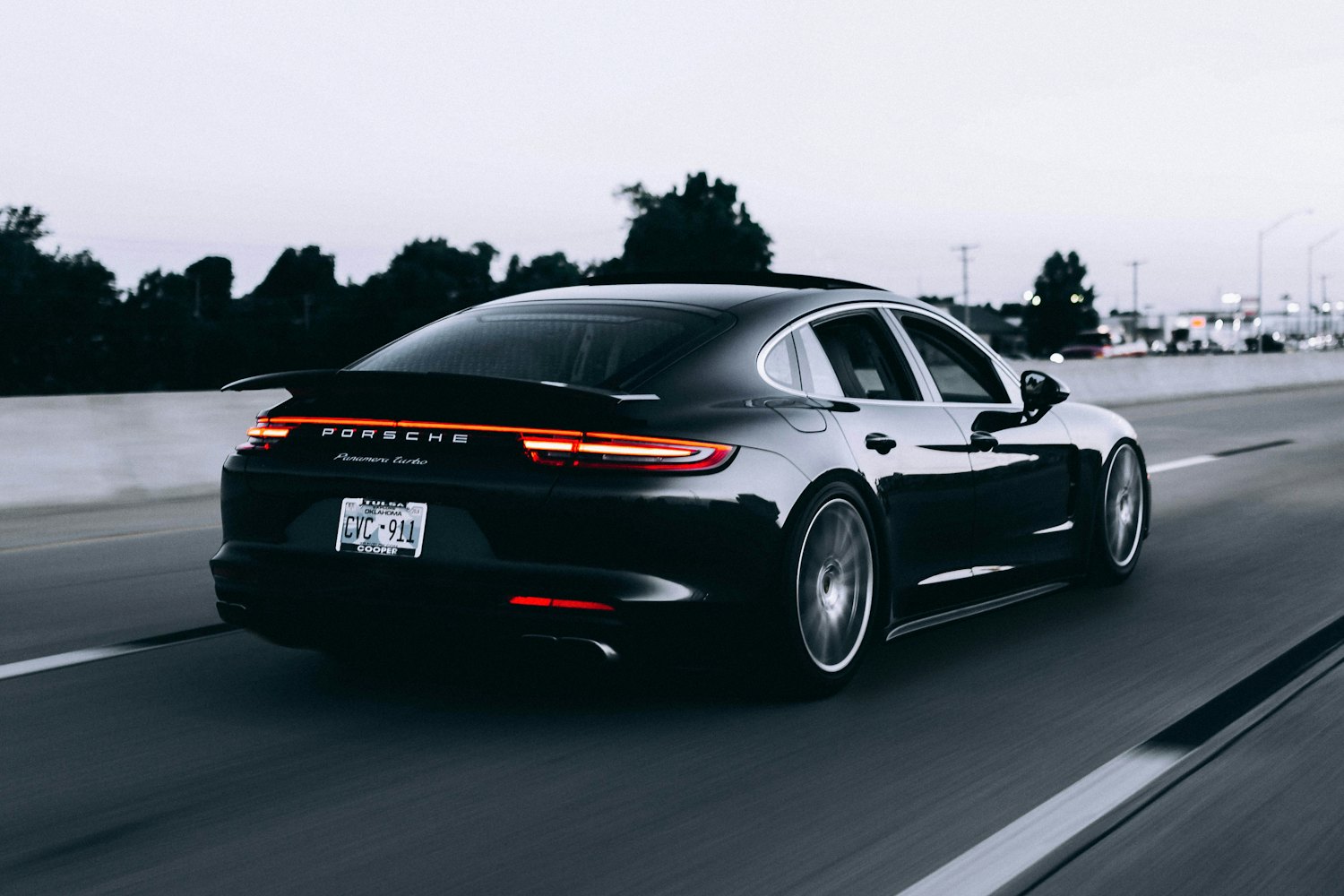 Black luxury sedan with a deep gloss finish at dusk